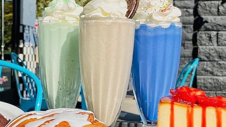 Colorful milkshakes with desserts