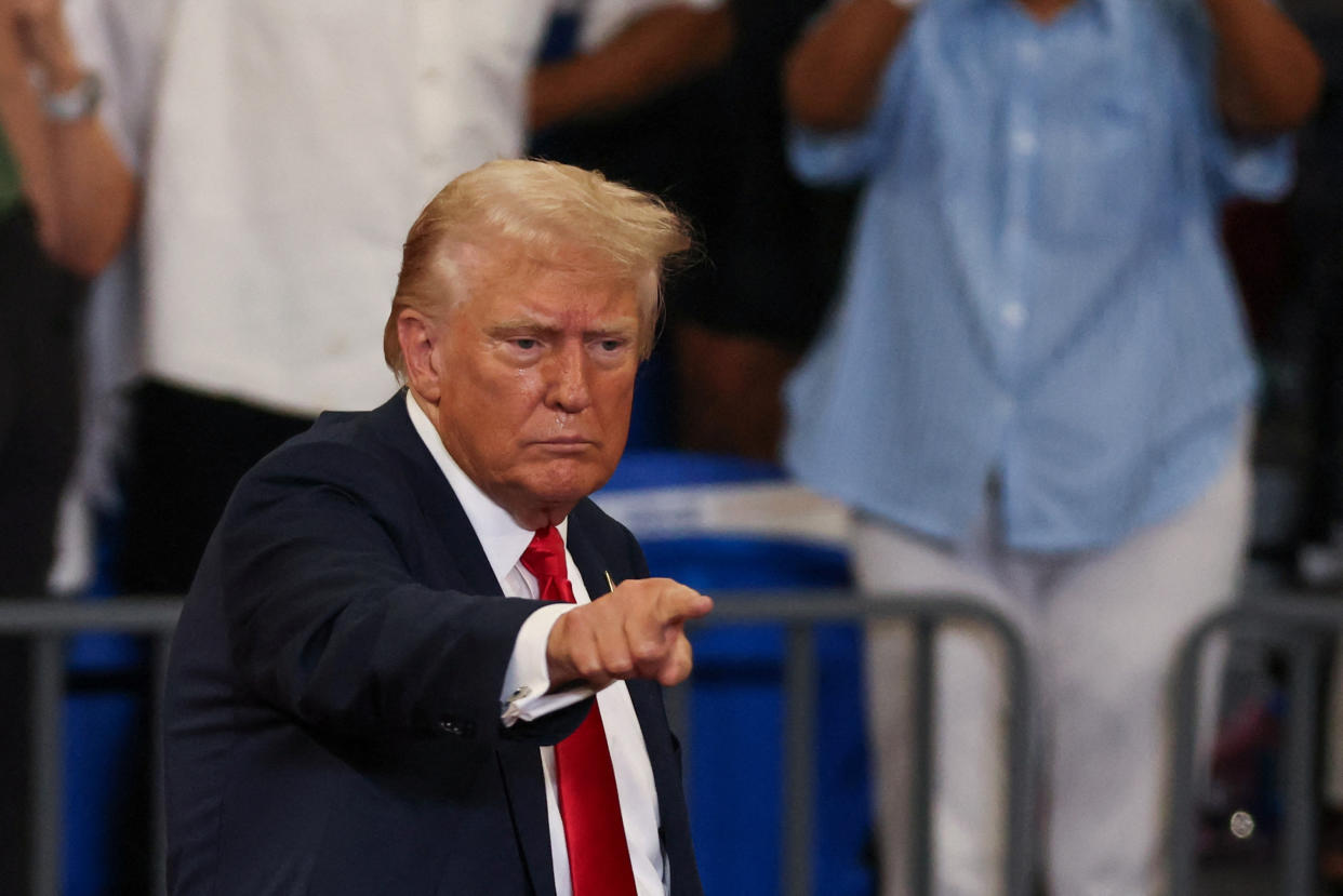 Republican presidential nominee former President Donald Trump points toward the audience at a rally.