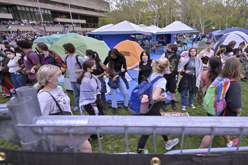 Demonstrators storm breached barriers to join a pro-Palestinian encampment, Monday, May 6, 2024, in at MIT in Cambridge, Mass. (AP Photo/Josh Reynolds)