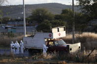 Police inspect an abandoned truck that was modified into a ram, found on the outskirts of Tula after a gang rammed several vehicles into a prison and escaped with nine inmates, in Tula, Mexico, Wednesday, Dec. 1, 2021. (AP Photo/Ginnette Riquelme)