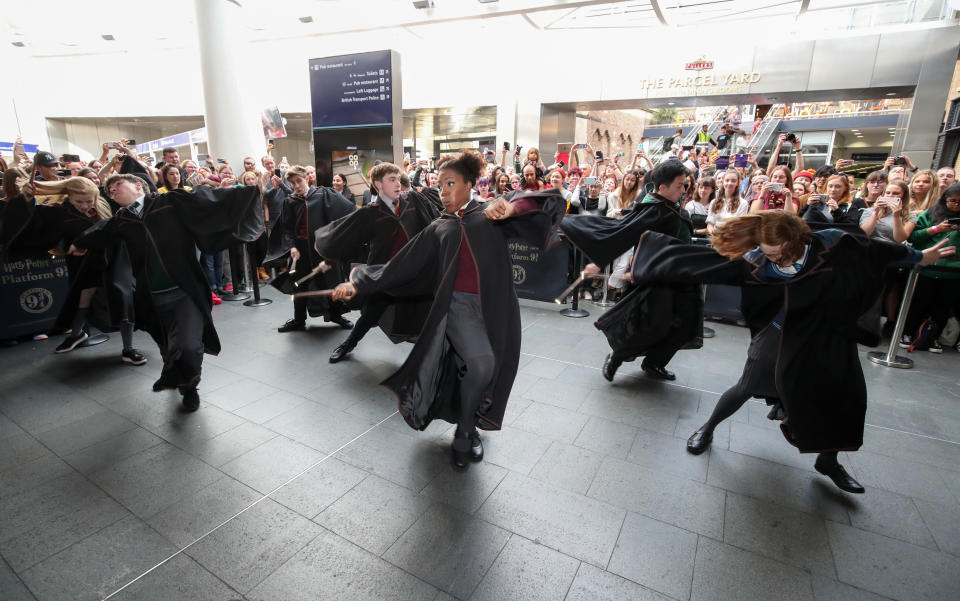 Cast members from Harry Potter and the Cursed Child perform at London Kings Cross Station as Harry Potter fans gather to watch as the Hogwarts Express appears on the departure board at London King's Cross during Back to Hogwarts Day. (Photo by Chris Radburn/PA Images via Getty Images)