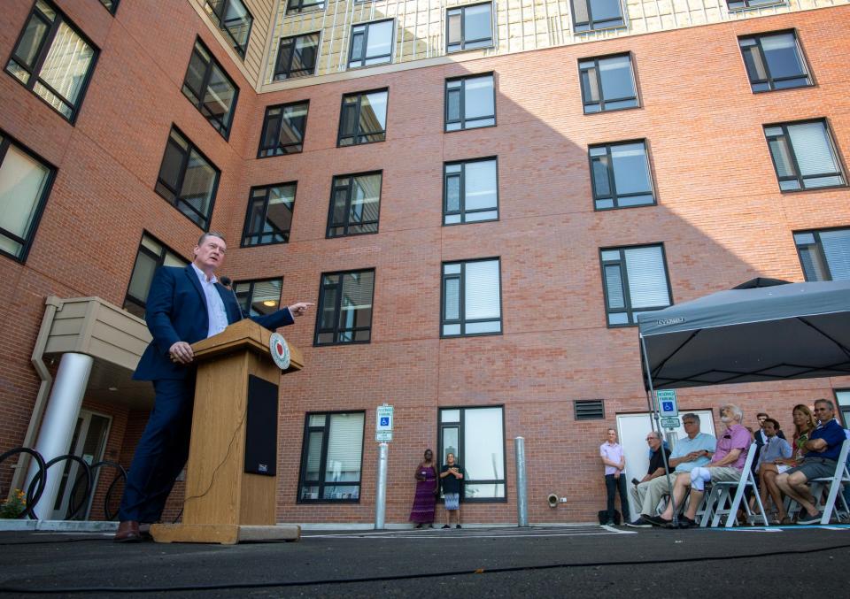 Massachusetts Secretary of Housing and Livable Communities Edward M. Augustus Jr. speak during the ribbon-cutting ceremony for the District 120 apartment building in the Canal District Tuesday.