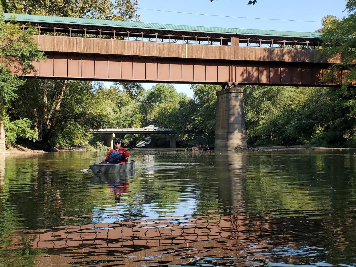 From the Bridge of Dreams to dreaming big. Curtis Casto paddles on the Mohican River near the iconic Bridge of Dreams. He's on the brink of realizing a bigger dream — a 980-mile kayak trip covering the entire Ohio River.