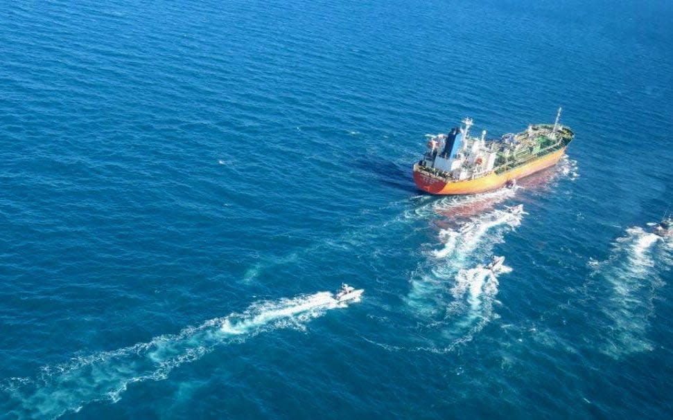 A picture obtained by AFP from the Iranian news agency Tasnim shows the South Korean-flagged tanker being escorted by Iran's Revolutionary Guards navy after being seized in the Gulf - -/AFP