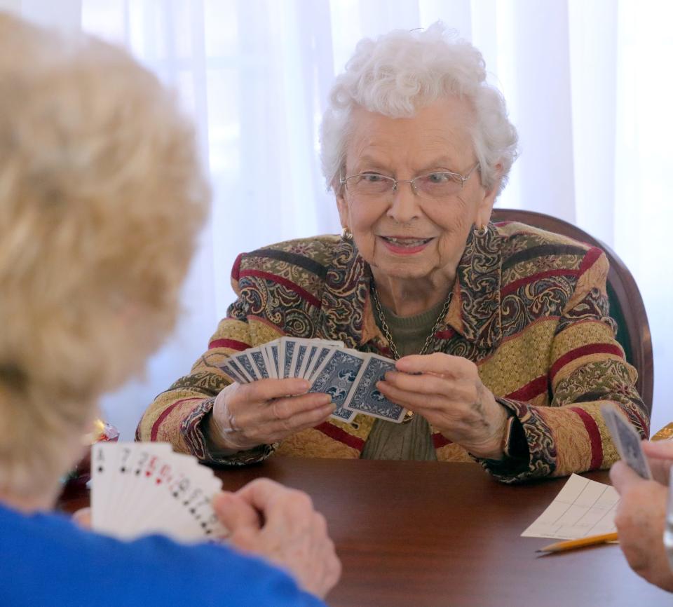 Former President Betty Huston, a 50-year member of the Akron Woman's City Club, plays a game of bridge with friends.