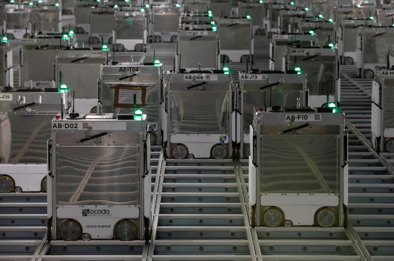 Ocado robots are seen inside a warehouse in Erith