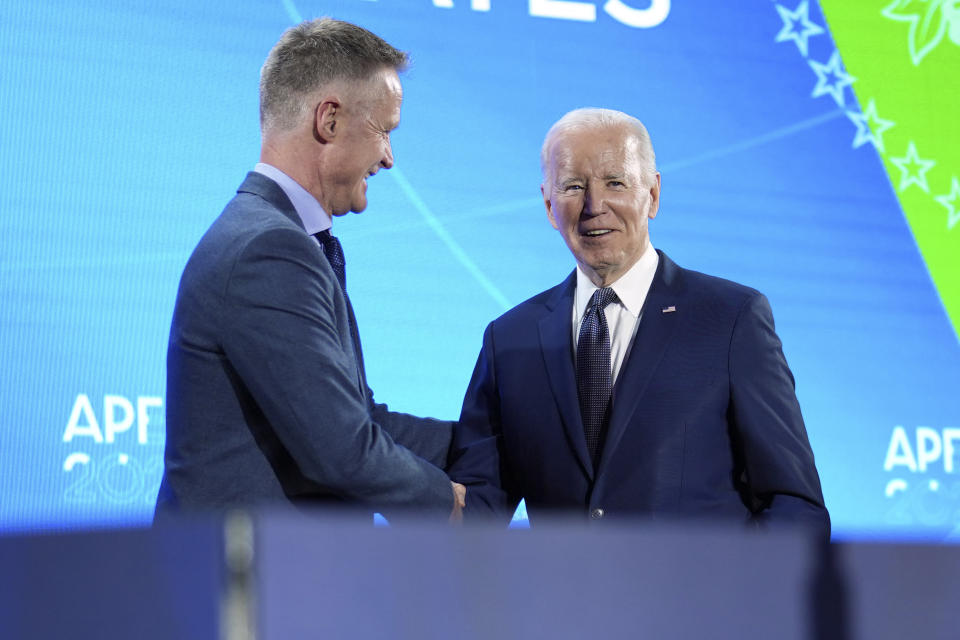 President Joe Biden shakes hands after Golden State Warriors head basketball coach Steve Kerr introduced him at a welcome reception for Asia-Pacific Economic Cooperative leaders at the Exploratorium, in San Francisco, Wednesday, Nov, 15, 2023. (Doug Mills/The New York Times via AP, Pool)