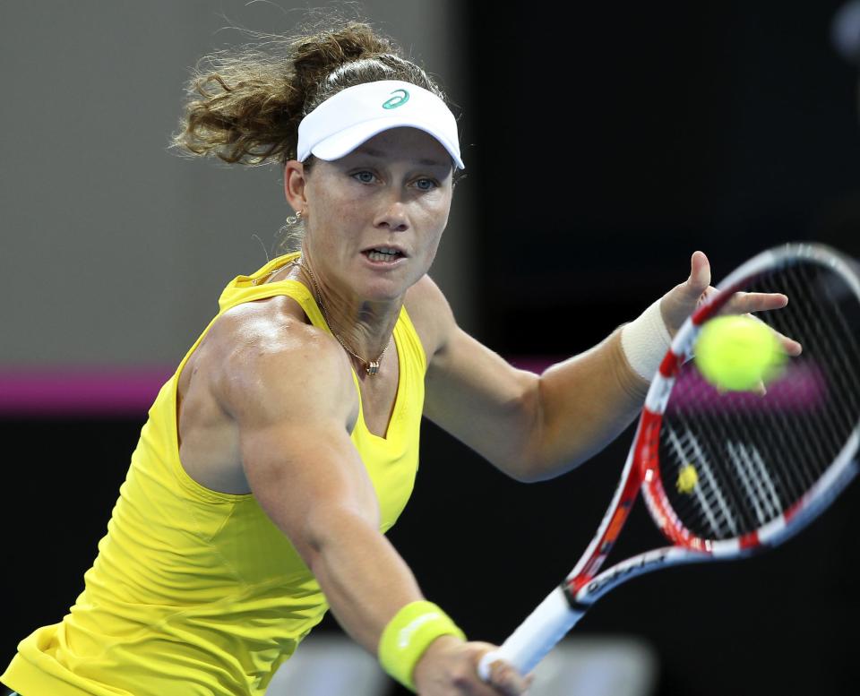 Samantha Stosur of Australia plays a shot in her match against Angelique Kerber of Germany during the Fed Cup semifinals between Australia and Germany in Brisbane, Australia, Sunday, April 20, 2014. (AP Photo/Tertius Pickard)