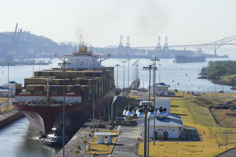 A cargo ship is guided by a tugboat through the Panama Canal's Cocoli locks, in Cocoli, Panama, Friday, March 10, 2023. (AP Photo/Arnulfo Franco)