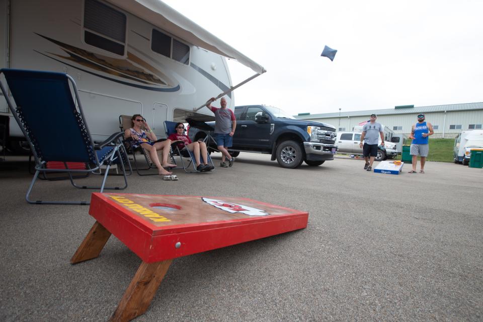 Brent Eisenbarth and Brian McClain play cornhole outside of their camper during the 2021 Country Stampede.