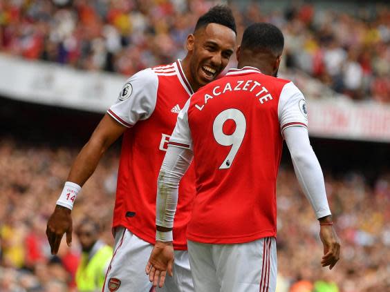 Aubameyang celebrates with strike partner Lacazette (AFP via Getty Images)