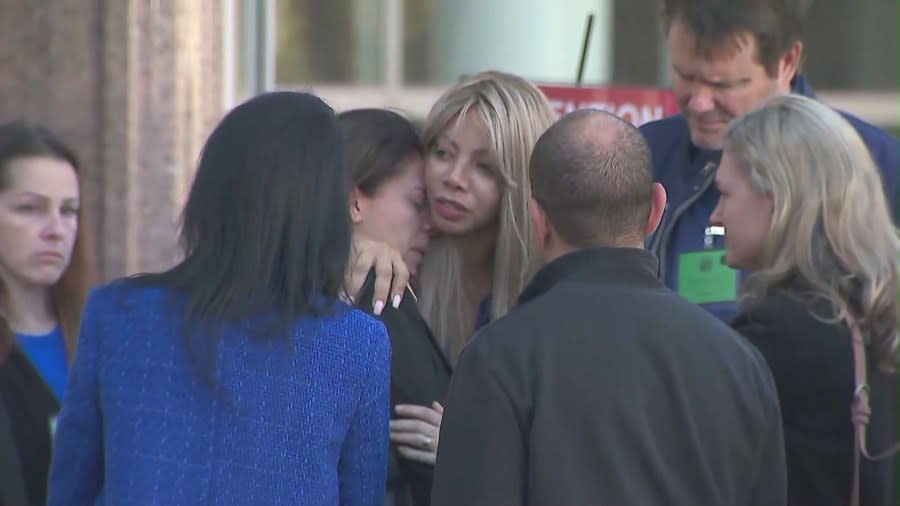 Nancy Iskander (center) is seen hugging loved ones after a day of deliberations in a Van Nuys courthouse on Feb. 22, 2024. (KTLA)