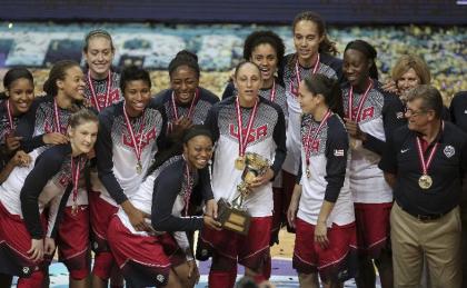 The United States basketball players and coach Geno Auriemma, right, pose with their trophy and gold medals following their victory over Spain in Basketball Championship for Women&#39;s final at Fenerbahce Arena in Istanbul, Turkey, Sunday, Oct. 5, 2014. Maya Moore scored 18 points and the U.S. beat Spain 77-64 to win its second straight gold medal in the championship. (AP Photo/Emrah Gurel)