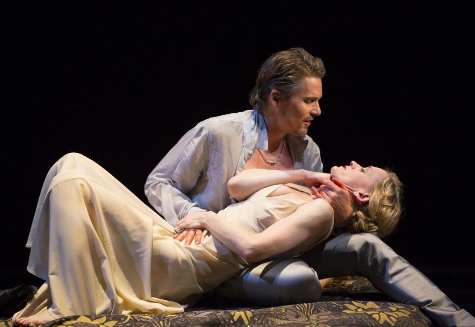 This image released by Lincoln Center Theater shows Ethan Hawke and Anne-Marie Duff during a performance of "Macbeth, in New York. Scott Pask's sets include giant moveable slabs, a vase of flowers that suddenly loses its petals and a bright, airy, leaf-covered canopy. Japhy Weideman's stunning lighting turns everyone into rock gods. And Catherine Zuber's timeless, ultra-sexy costumes make everyone gorgeous. (AP Photo/Lincoln Center Theater, T Charles Erickson)