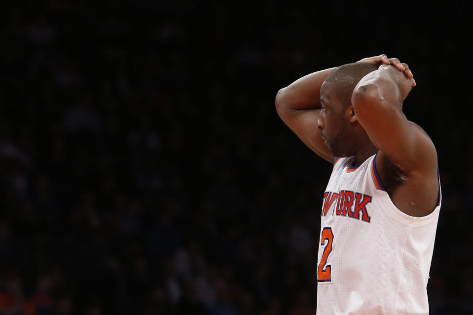 In this Monday, Feb. 24, 2014, photo, New York Knicks' Raymond Felton reacts during the second half of an NBA basketball game against the Dallas Mavericks in New York. Felton was arrested Tuesday on weapons charges after a lawyer for Felton's wife turned in a loaded gun allegedly belonging to the basketball star, saying she didn't want it in her home, police said. Felton turned himself in at 12:50 a.m. Tuesday, not long after the Knicks lost to the Mavericks. (AP Photo/Jason DeCrow)