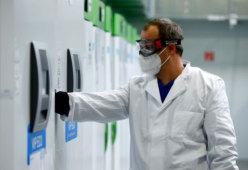 FILE PHOTO: An employee opens an ultra-cold refrigerator filled with vaccines against the coronavirus disease (COVID-19) at a secret storage facility in the Rhein-Main area