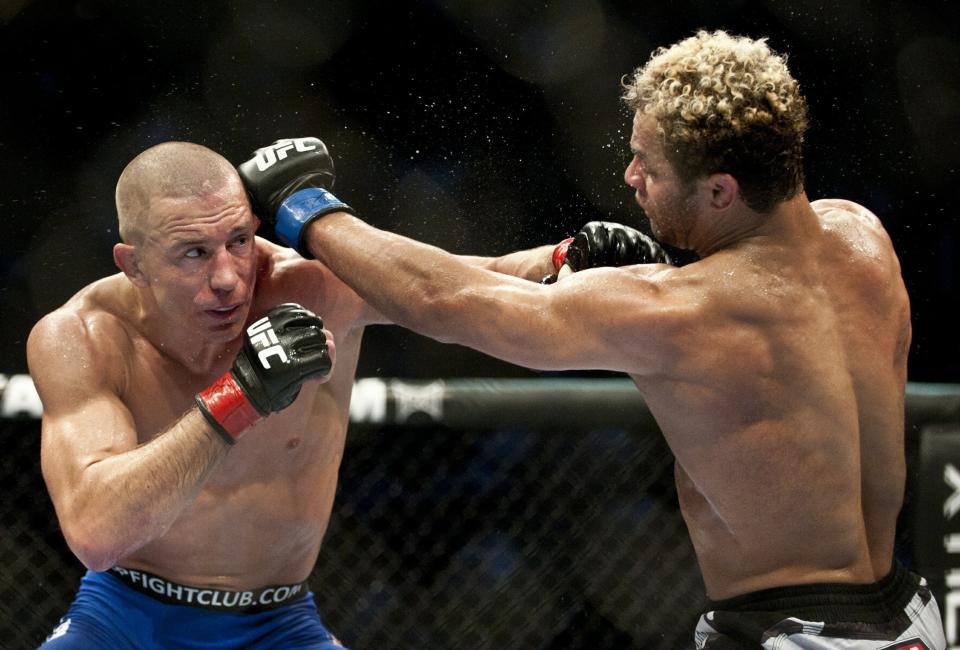 Georges St-Pierre (L) from Montreal, Canada battling with Josh Koscheck from Waynesburg US on the third round during the Ultimate Fighting Championship on December 11, 2010 at Bell Centre in Montreal, Quebec, Canada. AFP PHOTO / ROGERIO BARBOSA (Photo credit should read ROGERIO BARBOSA/AFP/Getty Images)