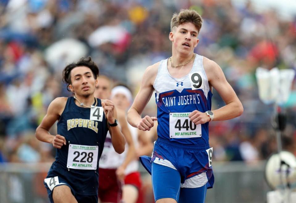 Saint Joseph’s Catholic’s Colin Simander, right, competes in the boys Class 2A 1600 meter run finals during the 2022 PIAA State Track and Field Championships.