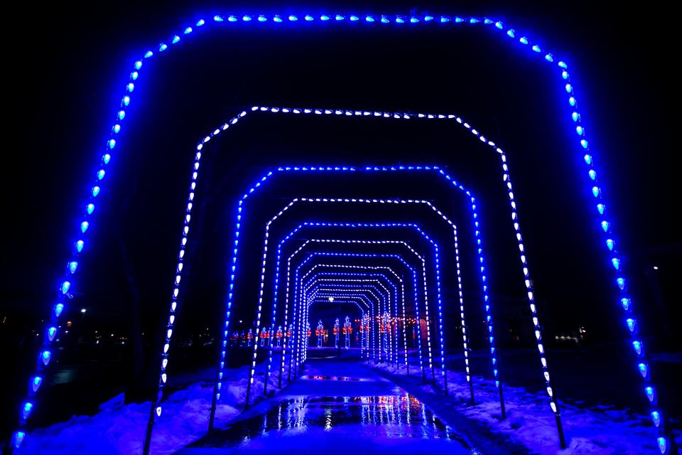 An installation of lights are illuminated around the Liberty Centre Pond, Thursday, Jan. 13, 2022, in North Liberty, Iowa.