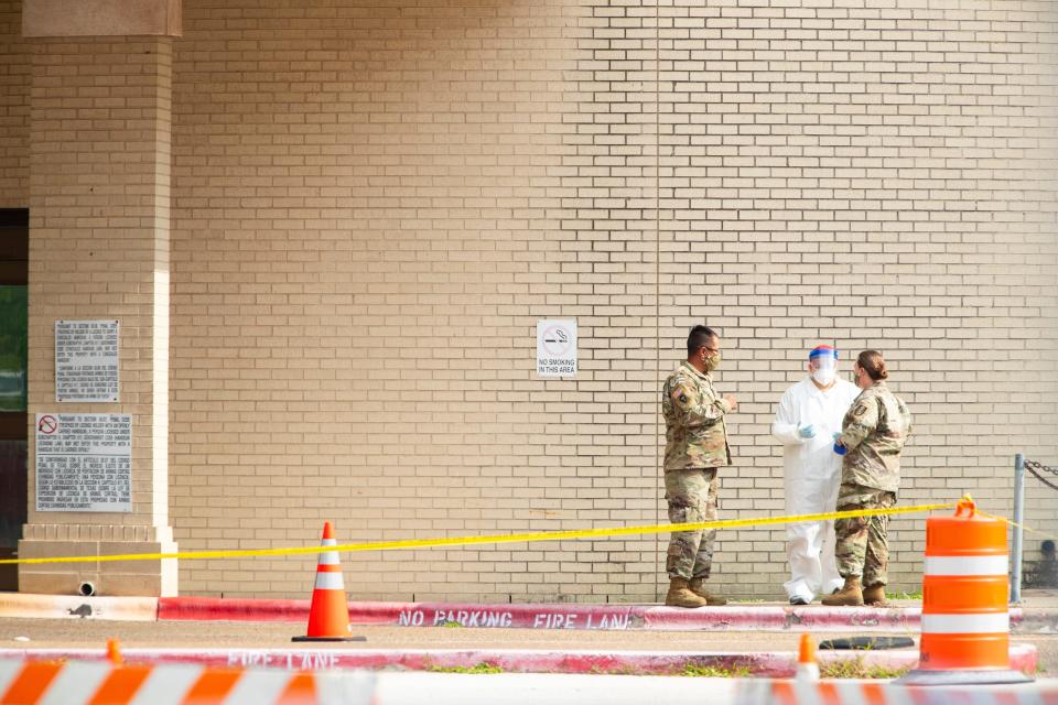 The Texas National Guard conducts drive-thru coronavirus testing in the old Christus Spohn Memorial Hospital parking lot Thursday in Corpus Christi.