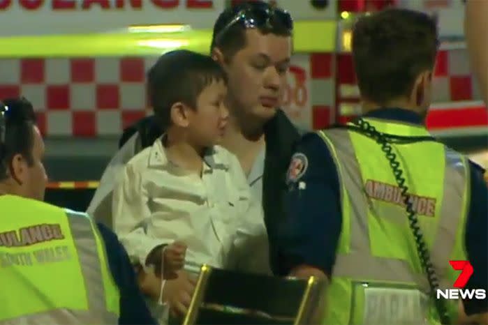 Jason Saeter holds his injured child following the explosion. Source: 7 News