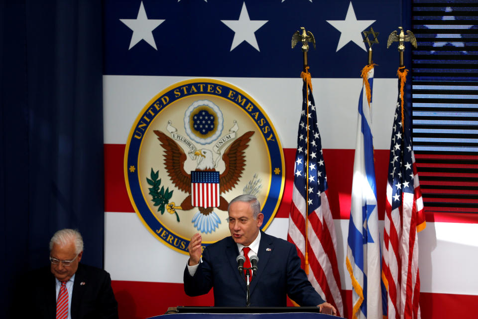 Israeli Prime Minister Benjamin Netanyahu speaks as U.S. Ambassador to Israel David Friedman sits next to him during the dedication ceremony of the new U.S. embassy in Jerusalem