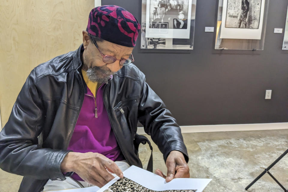 Akinyele Sadiq discusses photos taken of the crowd near the stage of the Woodstock festival in August 1969, May 9, 2023, in San Francisco, before being interviewed by the curators for the Museum at Bethel Woods as part of an effort to collect oral histories from people who were there. (AP Photo/Michael Liedtke)