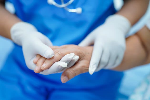 Midsection Of Doctor Consoling Patient In Hospital