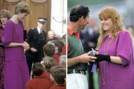 <p>In 1986, Princess Diana wore a magenta drop-waist dress with a short strand of pearls to visit the hospice at St John and St Elizabeth Hospital in London. </p><p>Sarah Ferguson repurposed the colorful dress as maternity wear when she was pregnant with Princess Beatrice. She’s seen here wearing it with black gloves and long gold necklaces on June 8, 1988, presenting Prince Charles with a prize after a polo match at Windsor Castle. (She wore a <a href="https://www.gettyimages.com/detail/news-photo/sarah-duchess-of-york-and-princess-michael-of-kent-in-the-news-photo/460678380" rel="nofollow noopener" target="_blank" data-ylk="slk:similar dress in yellow;elm:context_link;itc:0;sec:content-canvas" class="link ">similar dress in yellow</a> to the Royal Ascot a few days later.)</p>