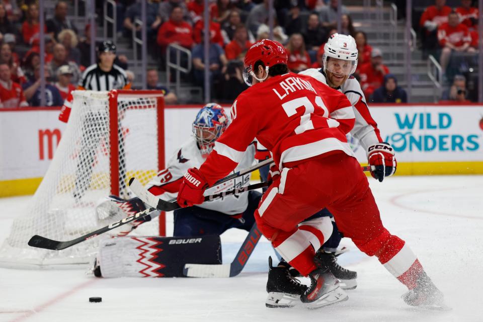 Capitals goaltender Charlie Lindgren makes a save on Red Wings center Dylan Larkin in the second period on Tuesday, April 9, 2024, at Little Caesars Arena.