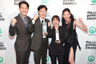 <p><em>Squid</em> <em>Game</em>'s Lee Jung-jae, Hwang Dong-hyuk, Kim Ji-yeon, and Jung Ho-yeon pose backstage with their awards at the 2021 Gotham Awards in New York City on Nov. 29.</p>