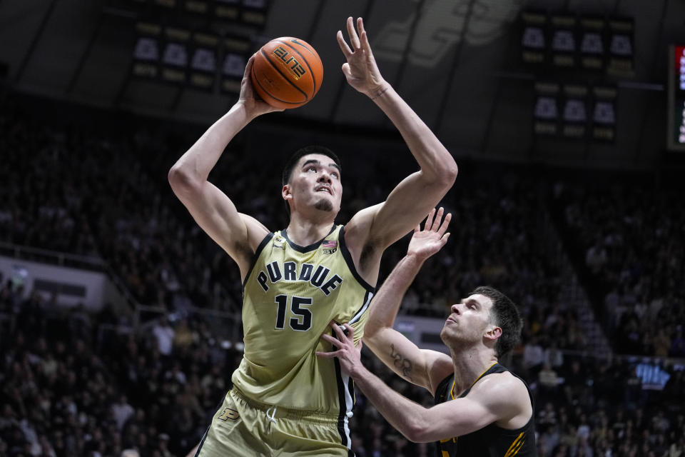 Purdue center Zach Edey (15) shoots over Iowa forward Filip Rebraca (0) during the second half of an NCAA college basketball game in West Lafayette, Ind., Thursday, Feb. 9, 2023. Purdue defeated Iowa. (AP Photo/Michael Conroy)