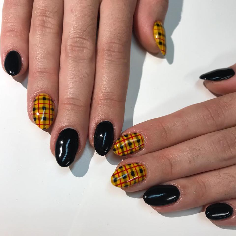 Anyone who's ever gone to a private school knows the combination of plaid skirts and black sweaters all too well. And while you don't have to wear those anymore, you can pay tribute to that back-to-school vibe with this manicure idea <a href="https://www.instagram.com/p/BrXqh_EAN7U/" rel="nofollow noopener" target="_blank" data-ylk="slk:by Savannah Walker;elm:context_link;itc:0;sec:content-canvas" class="link ">by Savannah Walker</a>. She painted some of her clients' nails solid black while hand-painting a yellow, black, and red plaid on the others.