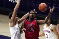 Eastern Washington guard Kim Aiken Jr. (24) drives past Arizona forward Ira Lee (11) during the second half of an NCAA college basketball game, Saturday, Dec. 5, 2020, in Tucson, Ariz. Arizona won 70-67. (AP Photo/Rick Scuteri)