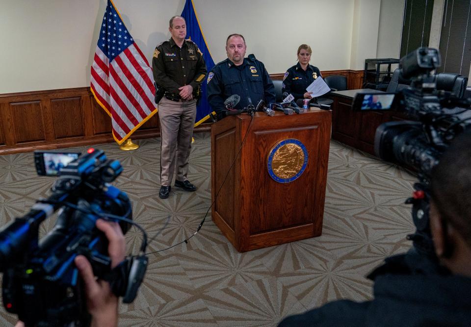 Vanderburgh County Sheriff Noah Robinson, left, Evansville Police Chief Billy Bolin, center, and Evansville Police spokeswoman Sgt. Anna Gray, right, address the media during a press conference related to the ongoing investigation of a Thursday night shooting at the West Side Walmart in Evansville, Ind., Friday afternoon, Jan. 20, 2022. Police identified the shooter as 25-year-old Ronald Ray Mosley II, a former Walmart employee who was charged with assaulting four people in the store last year.