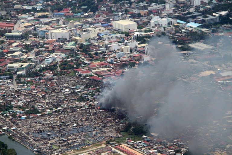 Houses burn during fighting between government forces and Muslim rebels in Zamboanga City, on September 17, 2013