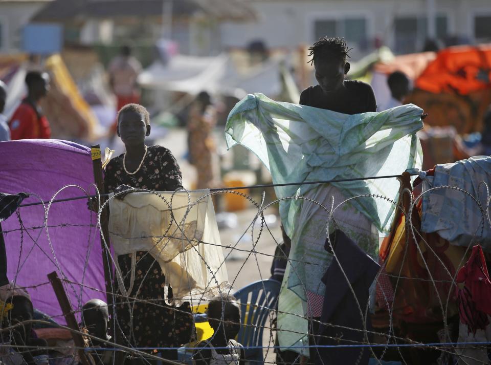 Internally displaced people stand inside a UNMIS compound in Juba