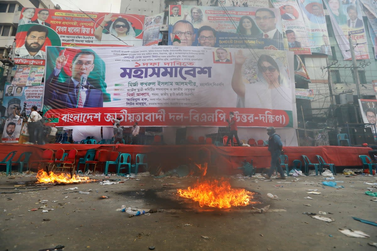 Smoke rises from flames near the stage set for a protest by the Bangladesh Nationalist Party in Dhaka, Bangladesh on 28 October (Associated Press)