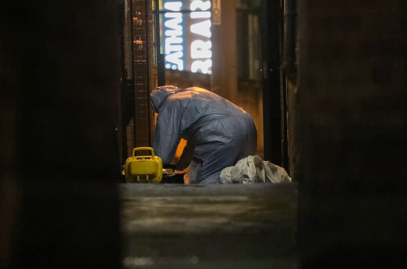 A police forensics officer is seen near a scene where a man was shot by armed officers in Streatham, south London