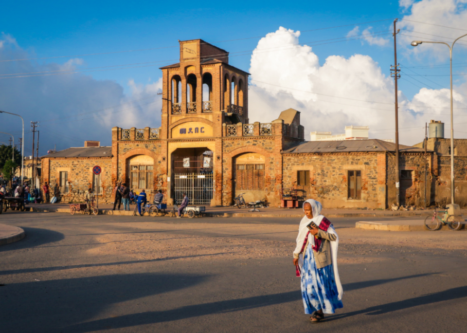 Woman crossing road by Medlar Market in Asmara