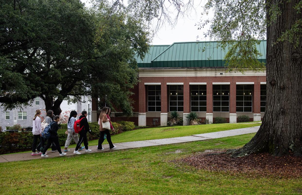 A group of students walk toward the McCravey-Triplett Student Center on the campus of Belhaven University in Jackson on Tuesday, Nov. 21, 2023.
