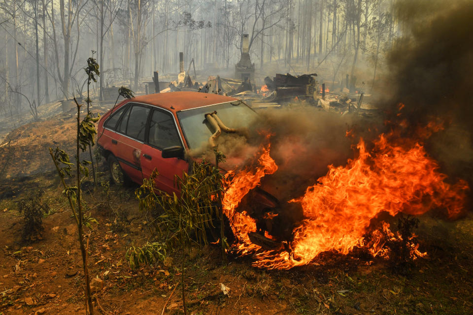 Pictures of homes and property destroyed in Hillville with a car on fire.