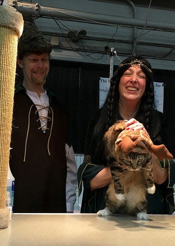 Robin Hood and Maid Marian seemed to enjoy their costumes at a prior cat show. The deer from the king's forest appeared less enthused.