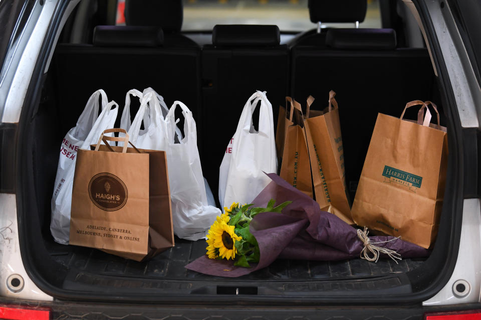 Pictured are paper bags full of product bought through the Westfield Direct service in the boot of a car. 