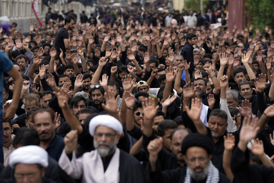 Shiite Muslims participate during a procession to mark Ashoura in Karachi, Pakistan, Friday, July 28, 2023. Ashoura is the Shiite Muslim commemoration marking the death of Hussein, the grandson of the Prophet Muhammad, at the Battle of Karbala in present-day Iraq in the 7th century. (AP Photo/Fareed Khan)
