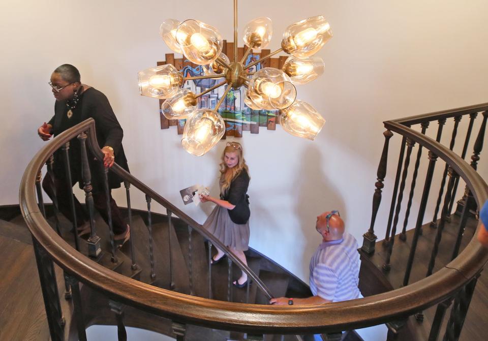 Akron City Council Member Linda Omobien, joins with others as they tour the Summit County Land Bank's new offices at the former home of John S. Knight in Akron on Friday.