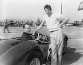 Charles Wallace, at wheel, Bethesda, Md., and Carroll Shelby, Dallas, Texas, are shown with the Aston Martin they will drive in the Grand Prix at Sebring, Fla., March 5, 1954. (AP Photo/James P. Kerlin)