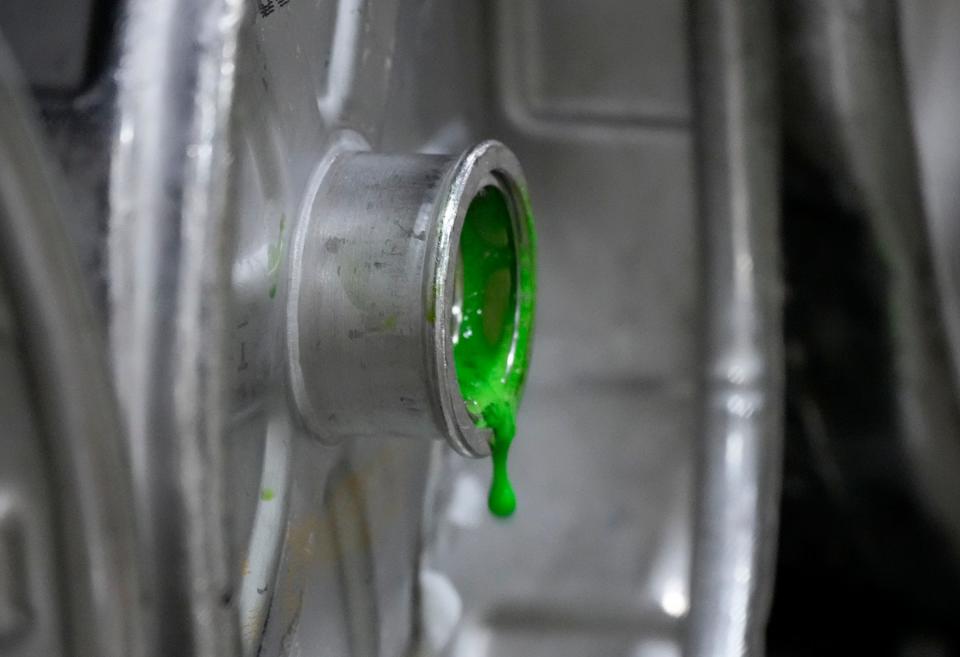 Green food coloring drips out of a keg after it’s added as part of the process of making green beer at Beer Capitol Distributing in Sussex.