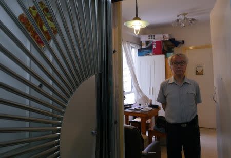 Landlord Ng Goon-lau, 66, poses inside his property where two suicides have taken place, in Hong Kong, China June 8, 2018. Picture taken June 8, 2018. REUTERS/Venus Wu