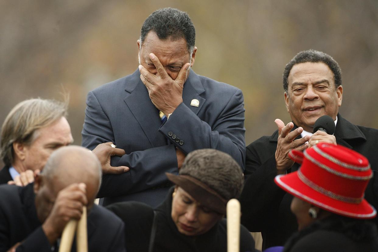 WASHINGTON - NOVEMBER 13:  Rev. Jesse Jackson (C) covers his face while weeping as Ambassador Andrew Young gives an invocation at the groundbreaking of the Martin Luther King Jr. National Memorial November 13, 2006 in Washington, DC. The memorial to the slain civil rights leader has been in the works for 10 years and will be situated on the National Mall near the Tidal Basin between the Lincoln and Jefferson memorials.  (Photo by Chip Somodevilla/Getty Images)